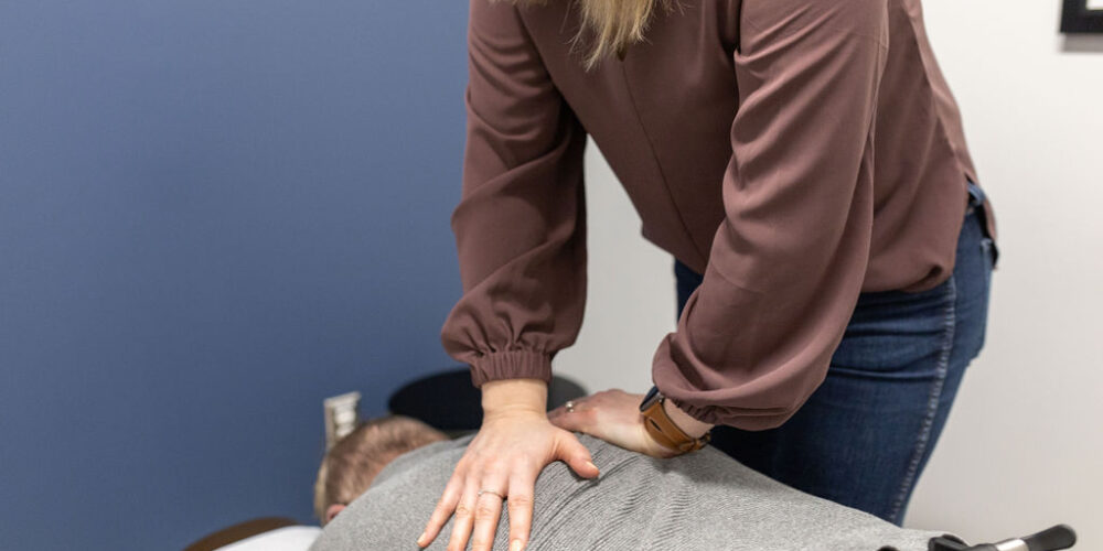 harmony chiropractic dr munn adjusting a patient lying face down on an adjusting table